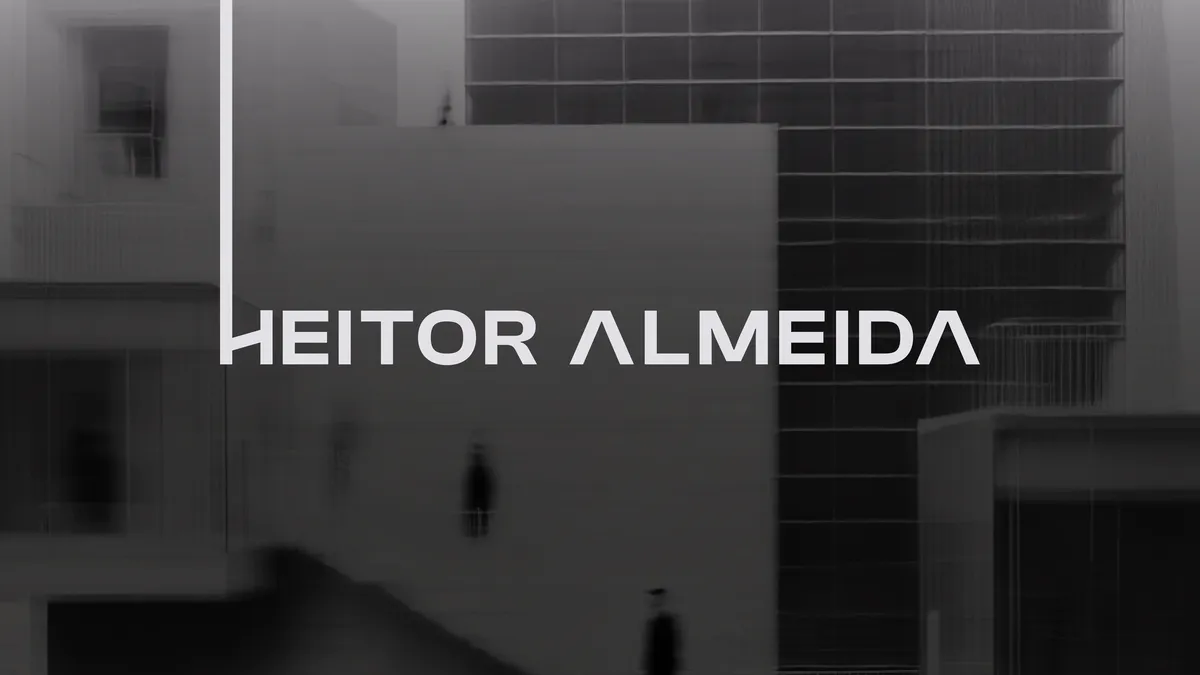 Logotipo de Heitor Almeida sobre fachada em preto e branco